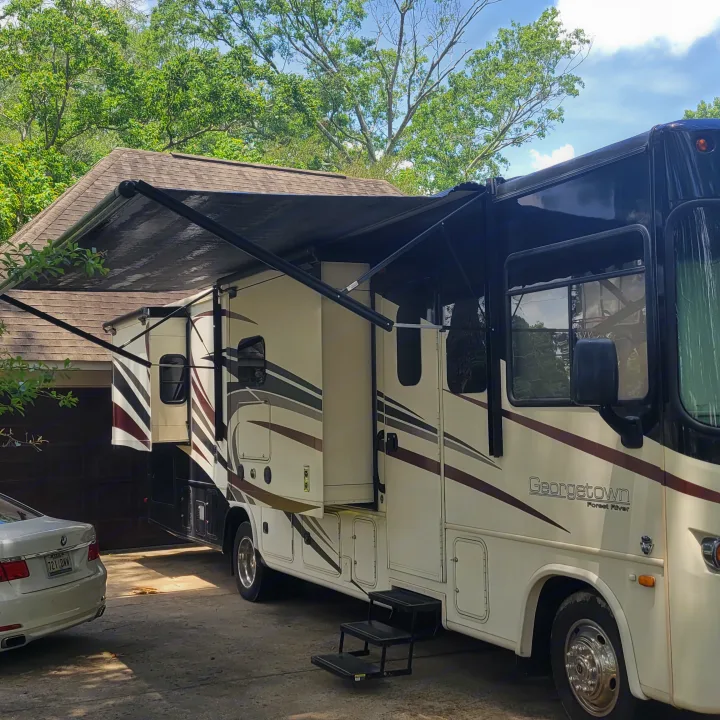 Spacious Georgetown RV rental, with awning and slide-outs extended, parked in a sunny driveway, ready for adventure.. Georgetown GT5 2017