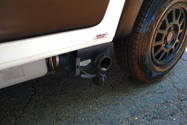 Under this RV rental, the gray waste tank drain & open dumping outlet are ready for use.. Winnebago Solis 2021