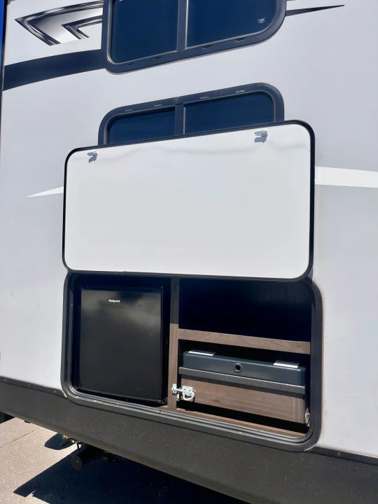 This RV rental features an accessible outdoor kitchen with a mini fridge & portable stove, enhancing your camping experience.. Keystone Bullet 2021