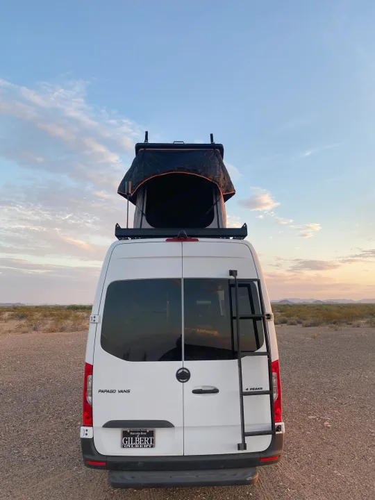 White Papago 4 Peaks camper van with rooftop tent in desert, ideal for an. Mercedes-Benz Sprinter 2022