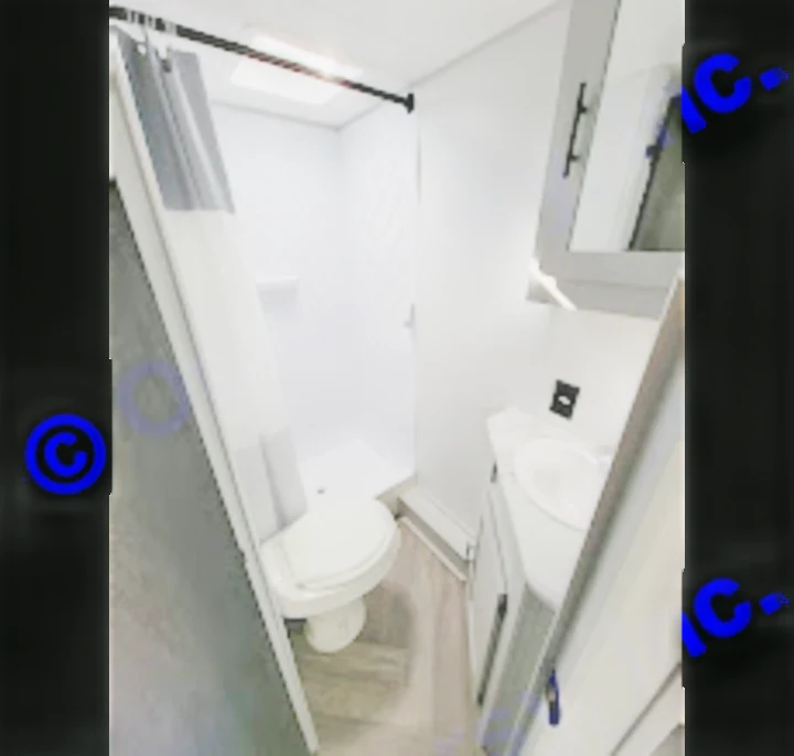 Compact & modern RV rental bathroom with shower, toilet, and vanity. Perfect for comfortable travel adventures!. Forest River Wildwood FSX 2021