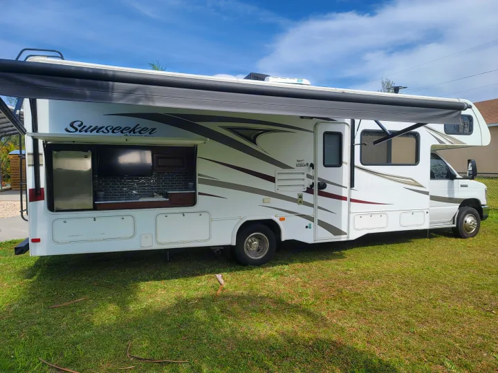 This Sunseeker RV rental, a Class C motorhome, boasts an outdoor kitchen and extended awning for ideal camping.. Forest River Sunseeker 2017