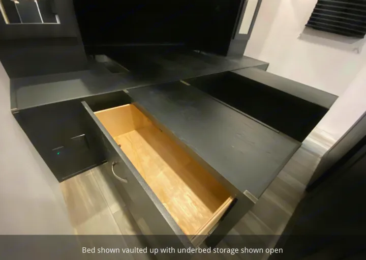 RV rental bed vaulted for underbed storage. Open drawer and deep compartments provide organized space.. Coachmen 257BHS 2022