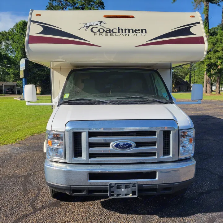 Front view of a white Coachmen Freelander RV rental on a Ford chassis, parked on pavement outdoors.. Forest River Coachmen Freelander 2016
