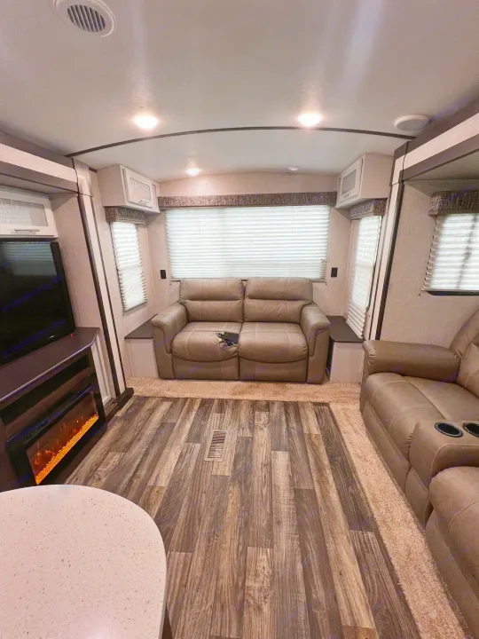 RV rental: Cozy living space featuring recliners, a fireplace, and stylish wood-look flooring.. Keystone RV Bullet Premier Ultra 2020