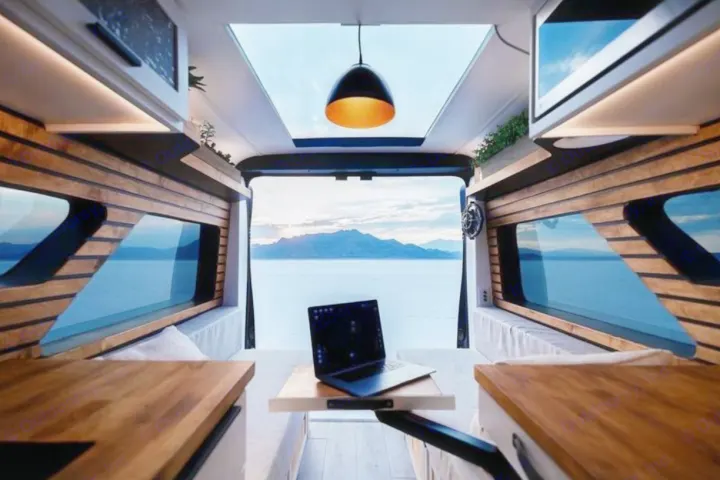 Experience luxury in an **RV rental**! A modern camper van interior with stunning views, ideal for remote work.. Dodge B Van 2020
