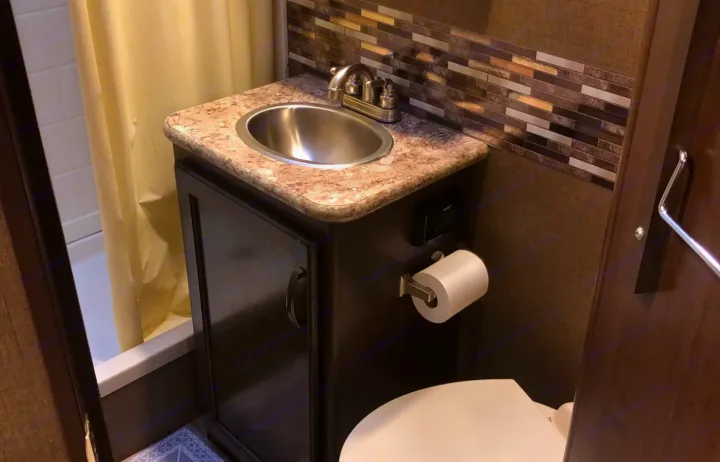 Functional RV rental bathroom with vanity, sink, toilet, and shower/tub combo. Compact design for comfortable travel.. Thor Four Winds 2018