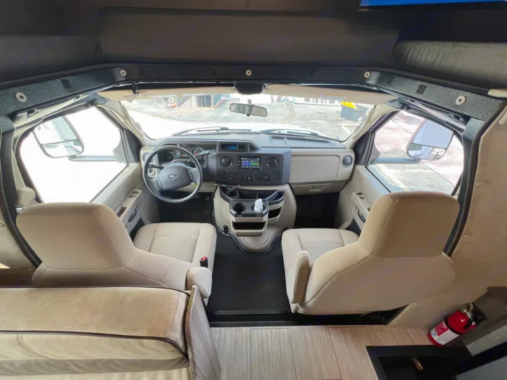RV rental front cabin interior: driver and passenger seats, dashboard, and steering wheel are clearly visible from an elevated view.. Nexus Triumph 23T 2020