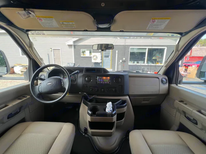 RV rental interior: spacious front cabin with Ford dashboard, steering wheel, and comfortable seats. "11'6" clearance" tag visible.. Nexus Triumph 23T 2020