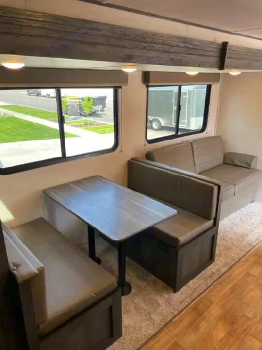 RV rental interior: Spacious living area with dinette & sofa for comfortable travel.. Keystone RV Hideout 2022