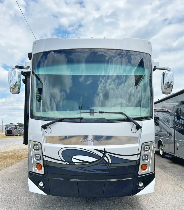 Front view of a white Berkshire motorhome, ideal for an RV rental adventure, reflecting cloudy skies.. Berkshire XLT 2023