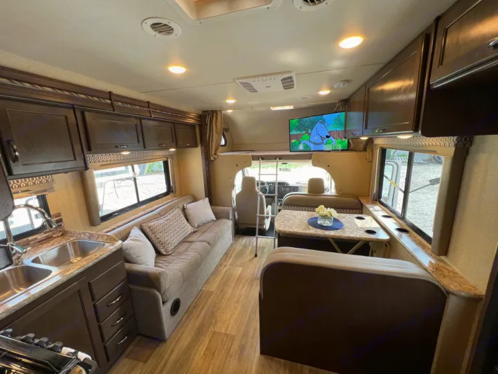 Peek inside this modern rv rental with full kitchen, comfy living area, dinette, and overhead cabinets.. Thor Motor Coach Freedom Elite 2017