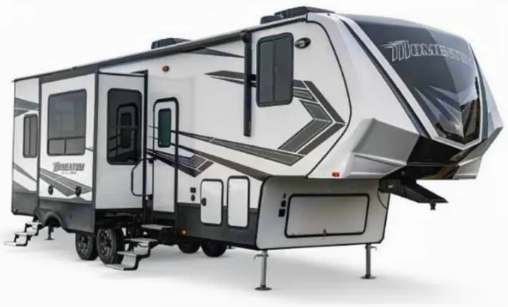 Discover this white & black fifth-wheel RV, perfect for your next RV rental. Large, with multiple slide-outs and steps deployed.. Grand Design Momentum 2021