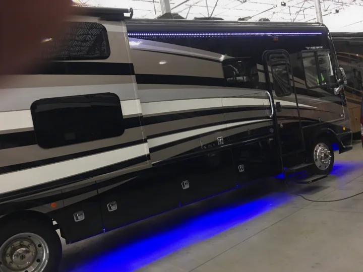 Sleek Fleetwood motorhome with cool blue underglow lighting, seen indoors. Perfect for your next rv rental adventure.. Fleetwood Bounder 2017