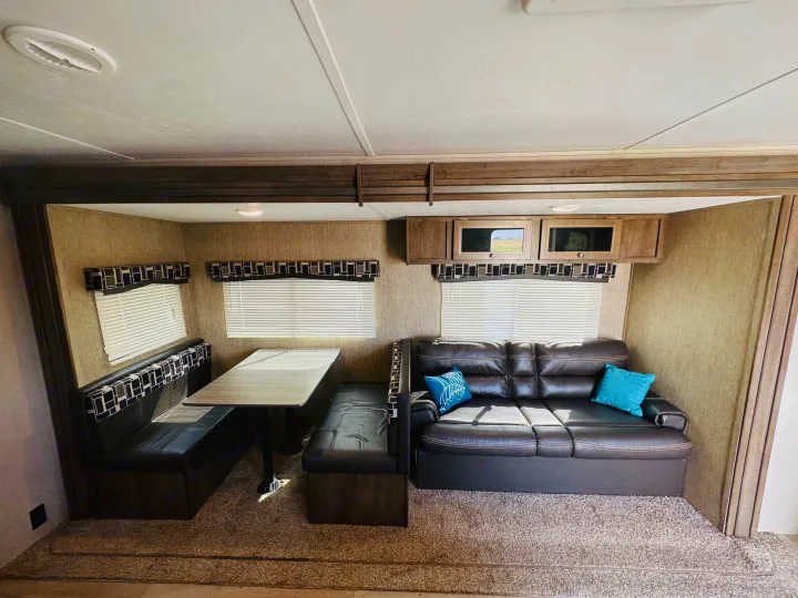 Step inside this cozy RV rental with a dining booth, large sofa, windows, and overhead storage.. Dutchmen Coleman Lantern 2019