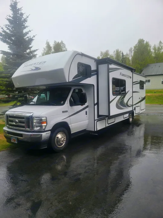 White Forester Class C RV rental parked on a wet asphalt driveway.. Forester LE 2022