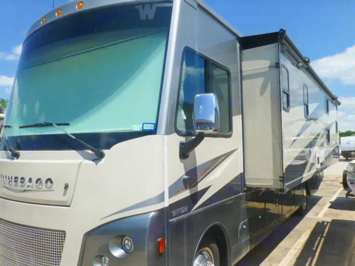 Large beige and gray Winnebago RV rental, a motorhome with an extended side slide-out for extra room.. Winnebago Vista 2020