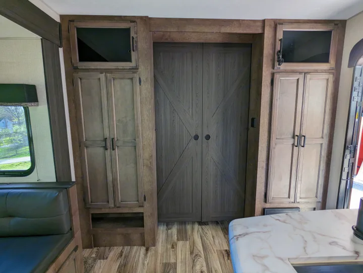 RV rental interior with tall cabinets, barn-style doors, and a kitchen counter.. Sport Trek Sport Trek Trailer 2021