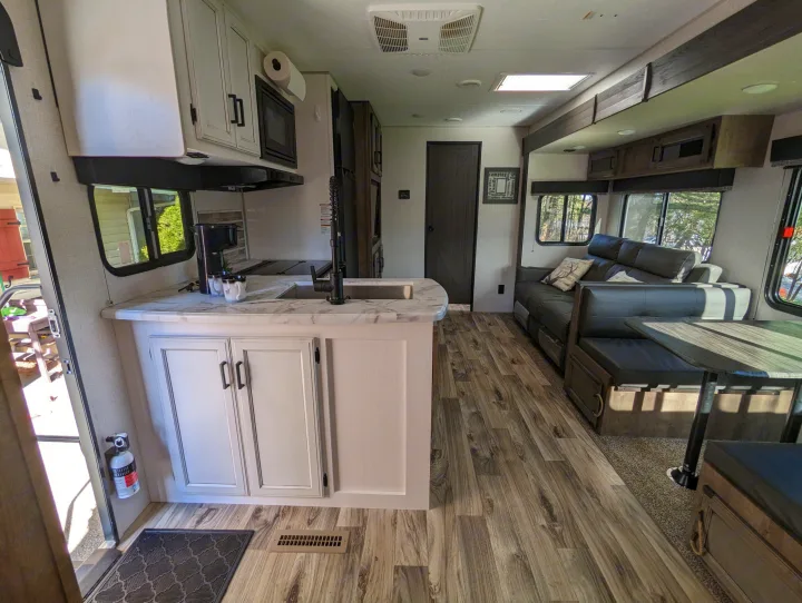 Step inside this inviting rv rental. Featuring a modern kitchen with a large counter, and a comfortable living/dining area.. Sport Trek Sport Trek Trailer 2021
