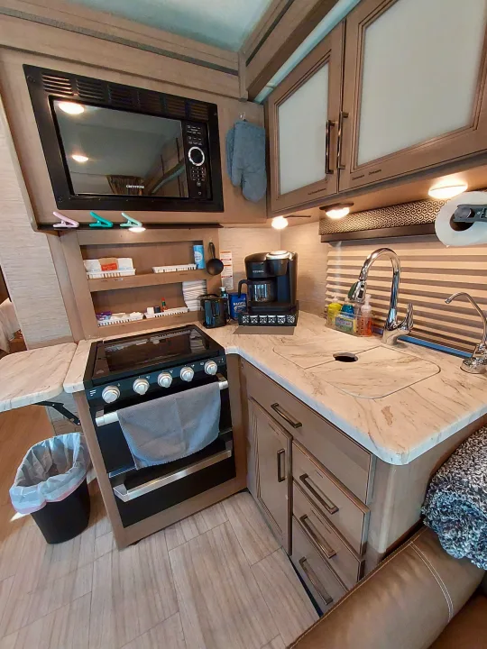 This RV rental features a compact kitchen with a sink, coffee maker, microwave, and oven for your road trips.. Thor Coleman 2021