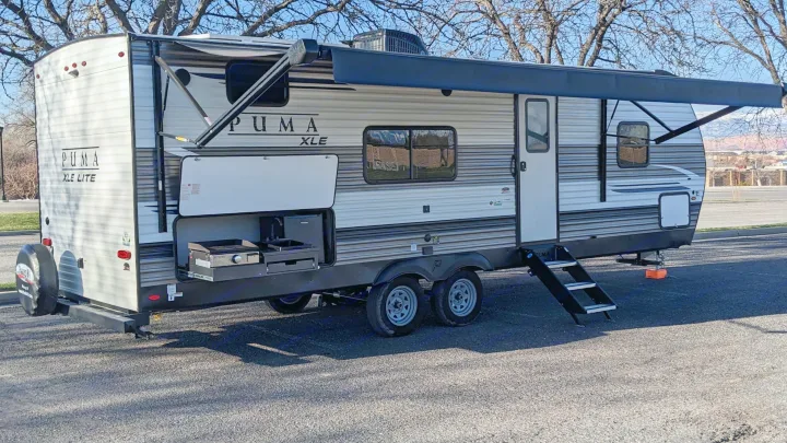 This PUMA XLE Lite RV rental, a travel trailer with an extended awning and outdoor kitchen, is ready for adventure.. Forest River Palomino Puma XLE 2022