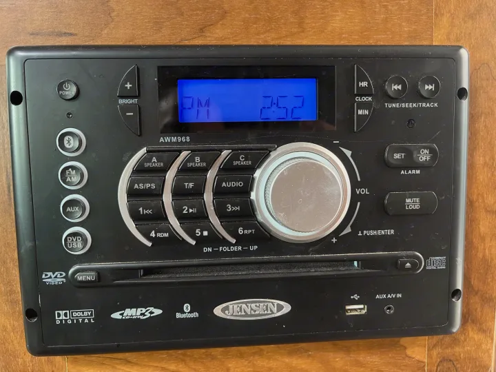 This Jensen AWM968 multimedia stereo, common in an RV rental, features DVD, USB, Bluetooth, and a digital clock.. Outdoors RV Creekside 2017
