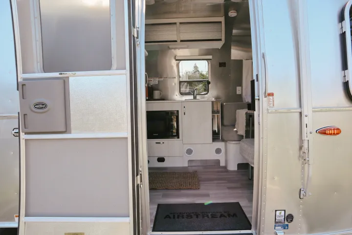 A peek inside an Airstream RV rental: modern kitchen, cozy living area, and space for adventure awaits.. Airstream Bambi 2023