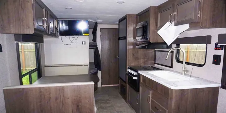 Inviting RV rental interior with a fully equipped kitchen, comfortable dinette, and cozy bunk beds.. Jayco Jay Flight SLX 2020