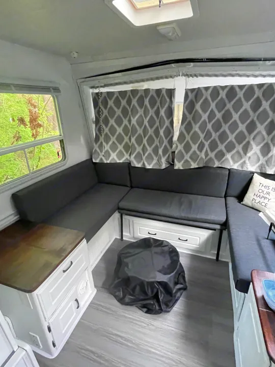 This is the seating under the bed agian also you can see the outdoor fire pit available as a add on for outdoor use . Coleman Caravan 2003