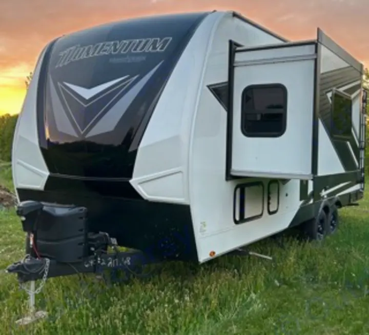 Explore in style! This white & black Momentum travel trailer with slide-out is ideal for an RV rental camping adventure.. Grand Design Momentum 2022