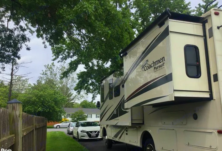 Coachmen Pursuit RV rental with slide-out extended, parked in a residential area. Explore motorhome travel.. Coachmen Pursuit 27DS 2019