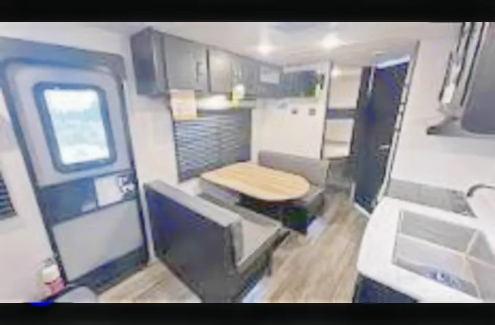 Step inside this RV rental: a modern interior with dinette, kitchen, and bunk beds, ready for your next trip.. Coachmen Freedom Express 2023
