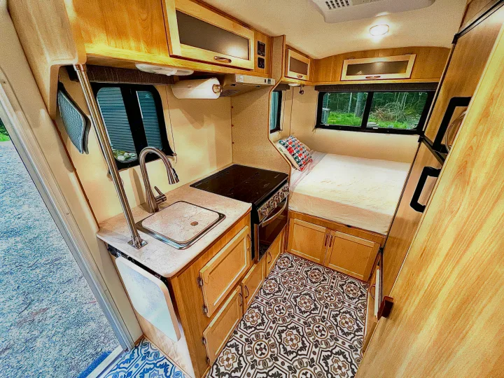 Compact travel trailer interior: bright RV rental with full kitchen, bed, and storage. Ideal for road trips.. Escape Trailer Escape Trailer Trailer 2022
