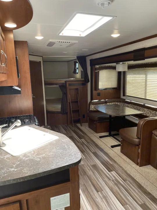 Spacious RV rental interior featuring a full kitchen, dinette, and bunk beds. Perfect for family adventures.. Jayco Jay Flight 2017
