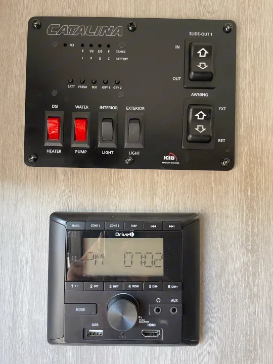 RV rental control panel & stereo: Tank levels, heater, pump, interior/exterior lights, slide-out, awning, and audio system.. Coachmen Catalina Summit 2022