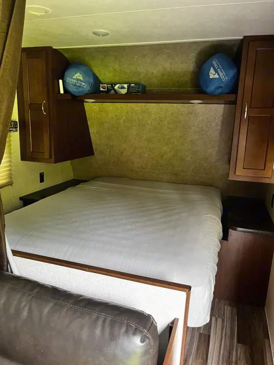 Comfortable RV rental bedroom with a large bed, built-in cabinets, and storage. Ready for your next road trip!. Jayco Jay Flight 2017