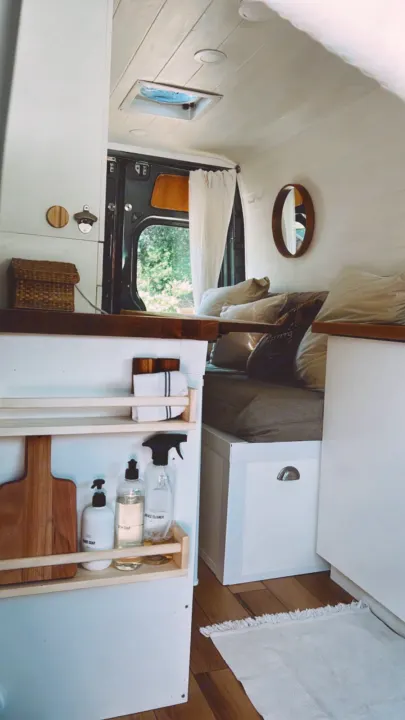 Cozy RV rental interior with organized kitchen storage, comfortable living area, and nature views. Perfect small space design.. Mercedes-Benz Sprinter 2016