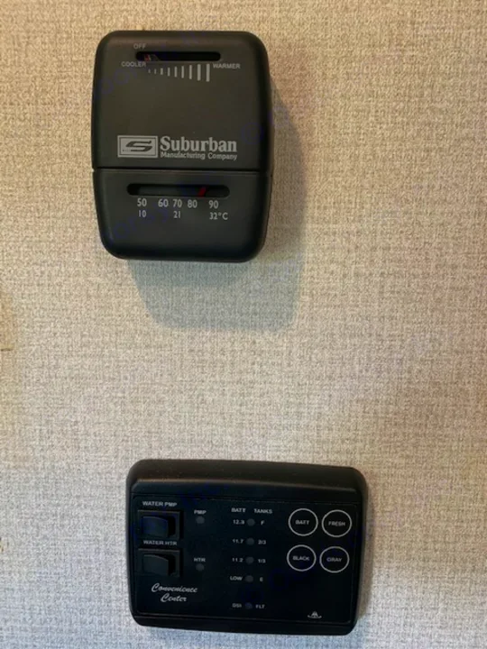 RV rental control panel and thermostat, showing tank levels, battery status, and temperature controls for a comfortable journey.. Keystone RV Hideout 2021
