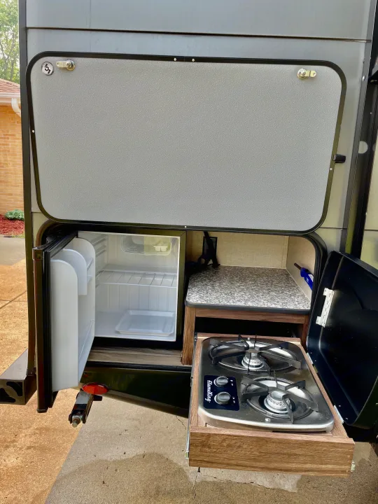 This RV rental features a convenient pull-out outdoor kitchen with a compact fridge and two-burner stove, great for camping.. Travel Lite Aura 2019