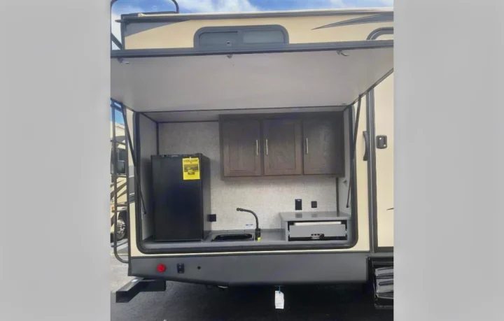 Outdoor kitchen with stove top, fridge, sink, and storage. Plugs for additional appliances. . Forest River Salem Hemisphere 2020