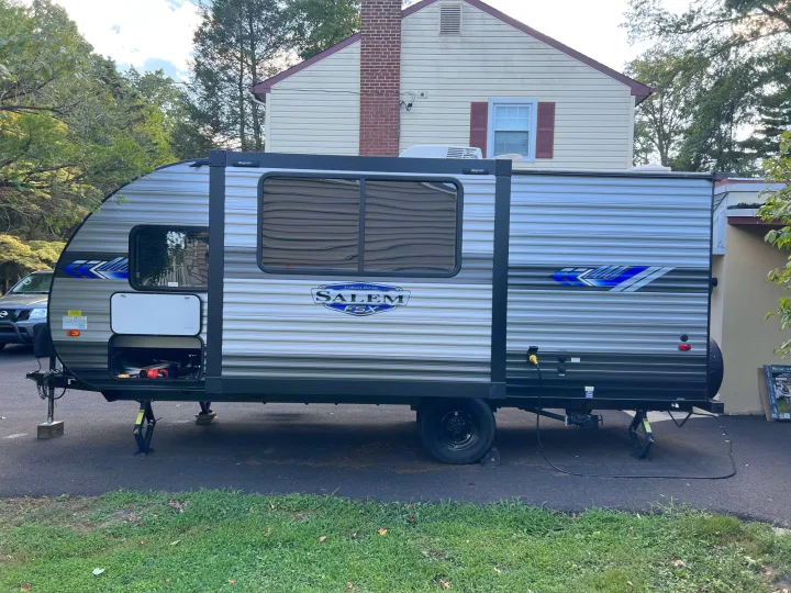 A modern Forest River Salem FSX travel trailer, perfect for your next rv rental, parked in a residential driveway.. Forest River Salem FSX 2022