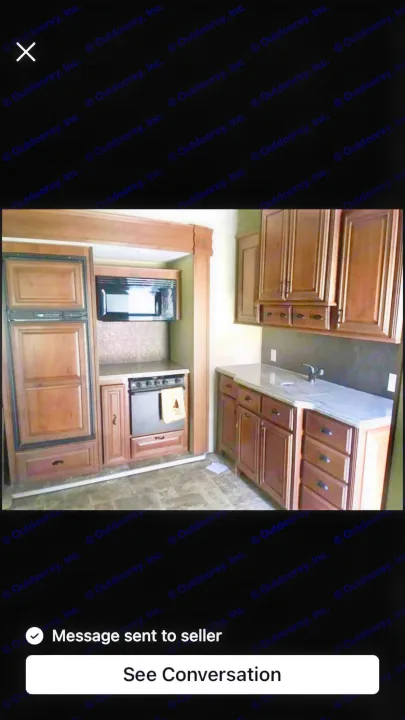 RV rental kitchen interior: compact design with fridge, microwave, stove, sink, and wood cabinets. Ideal for travel.. Open Range RV Open Range RV Fifth Wheel 2013