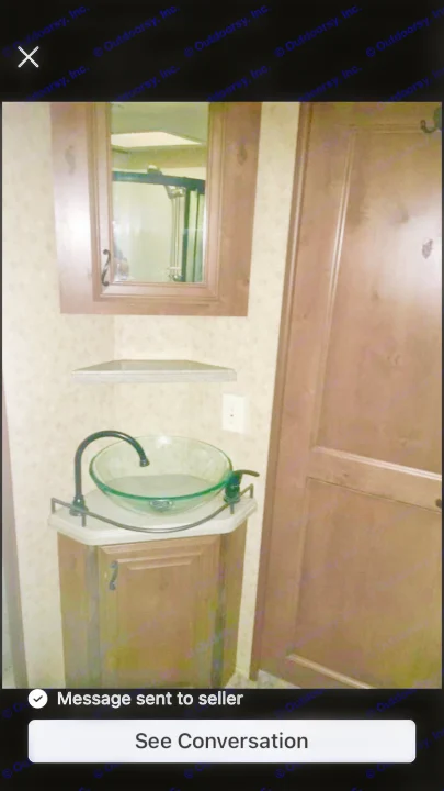 Compact RV rental bathroom featuring a glass vessel sink, dark wood vanity, mirror cabinet, and shower reflection. Functional design.. Open Range RV Open Range RV Fifth Wheel 2013
