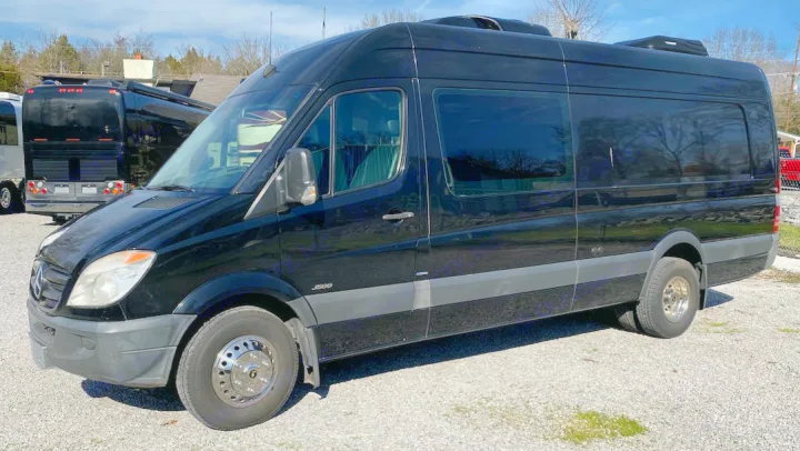 Black Mercedes-Benz Sprinter van, an ideal rv rental choice, featuring dual rear wheels. Ready for spacious travel adventures.. Mercedes-Benz Sprinter 2012