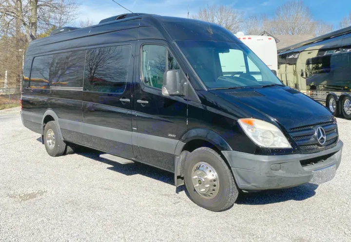 Black Mercedes-Benz Sprinter van on gravel lot, perfect for rv rental or custom conversion. Side steps and roof AC visible.. Mercedes-Benz Sprinter 2012