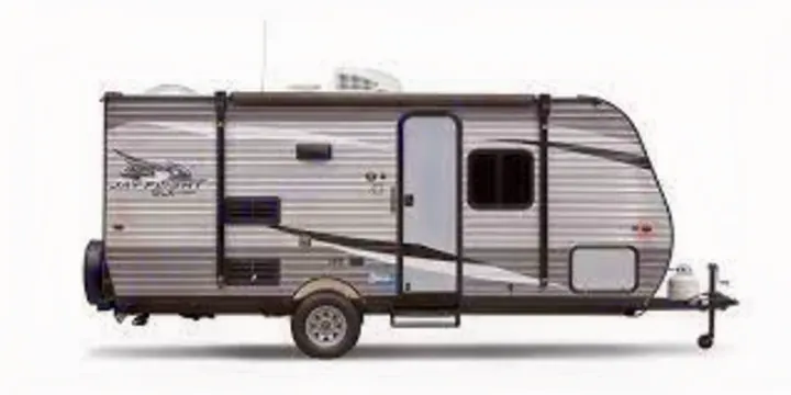 This modern grey travel trailer, suitable for an RV rental, is seen from its side, featuring a door, windows, and awning.. Jayco Jay Flight SLX 2020