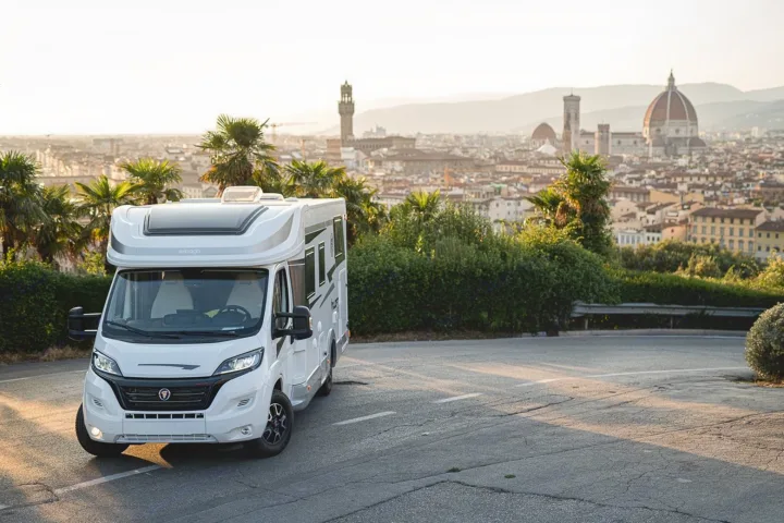 A white RV rental on a scenic road overlooking Florence, Italy, featuring the iconic Duomo and city skyline.. Elnagh 582 2023