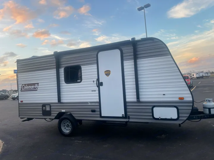 This compact Coleman travel trailer is ready for your next RV rental trip, showcasing its sleek design.. Coleman Lantern 17B 2023