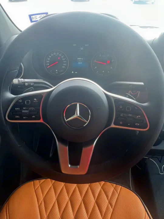 Detailed Mercedes-Benz vehicle interior, possibly an RV rental, showing steering wheel, digital dashboard, and 2809 miles.. Mercedes Benz Sprinter 2022