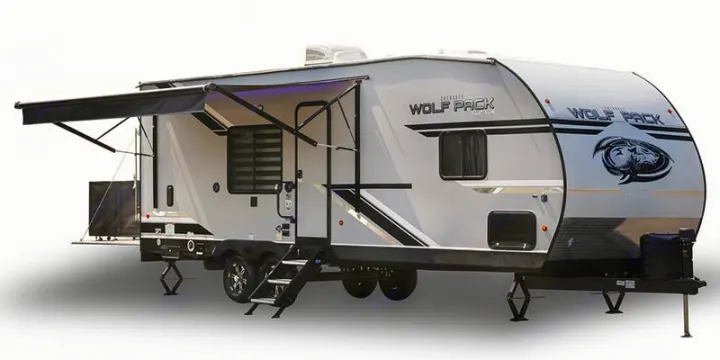 Modern Wolf Pack travel trailer RV rental, featuring an extended awning and accessible steps. Ideal for camping and travel.. Forest River Cherokee Wolf Pack 2020